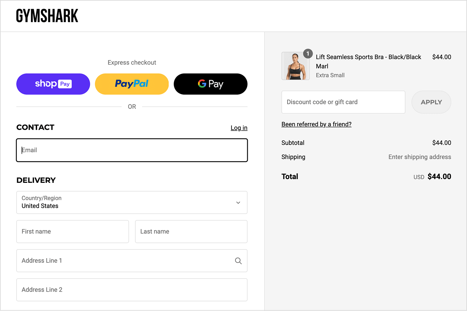 Gymshark shopping cart page with a sports bra, express checkout options, and delivery form.