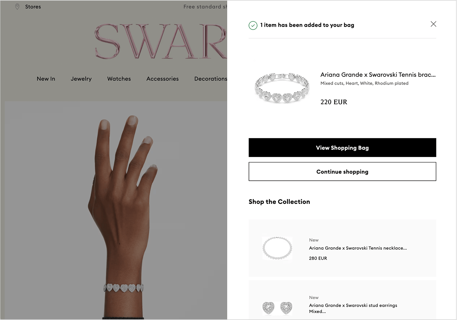 Swarovski floating cart summary with product details and upsells.